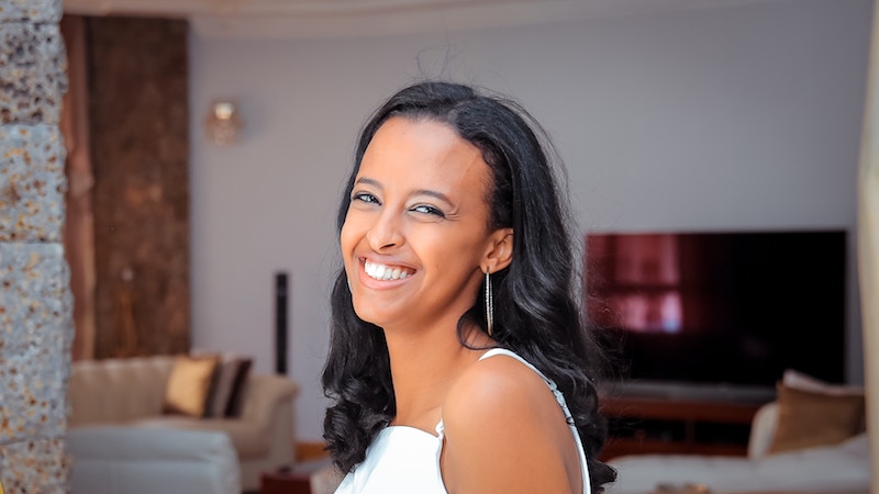 Image showing a college-aged woman on in a room with a moderately complex background.